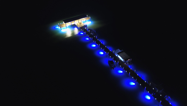 underwater lights illuminating a dock’s pathway and boats